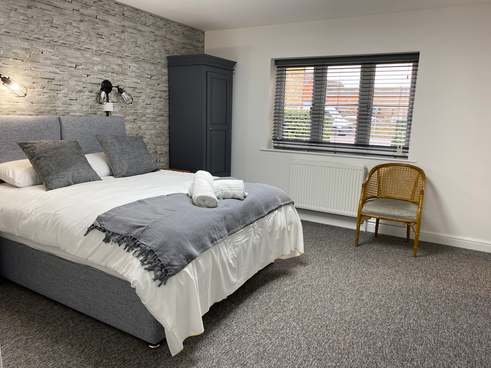 Modern stylish guest bedroom at The Roade House in Roade with a large bed and contemporary decor.
