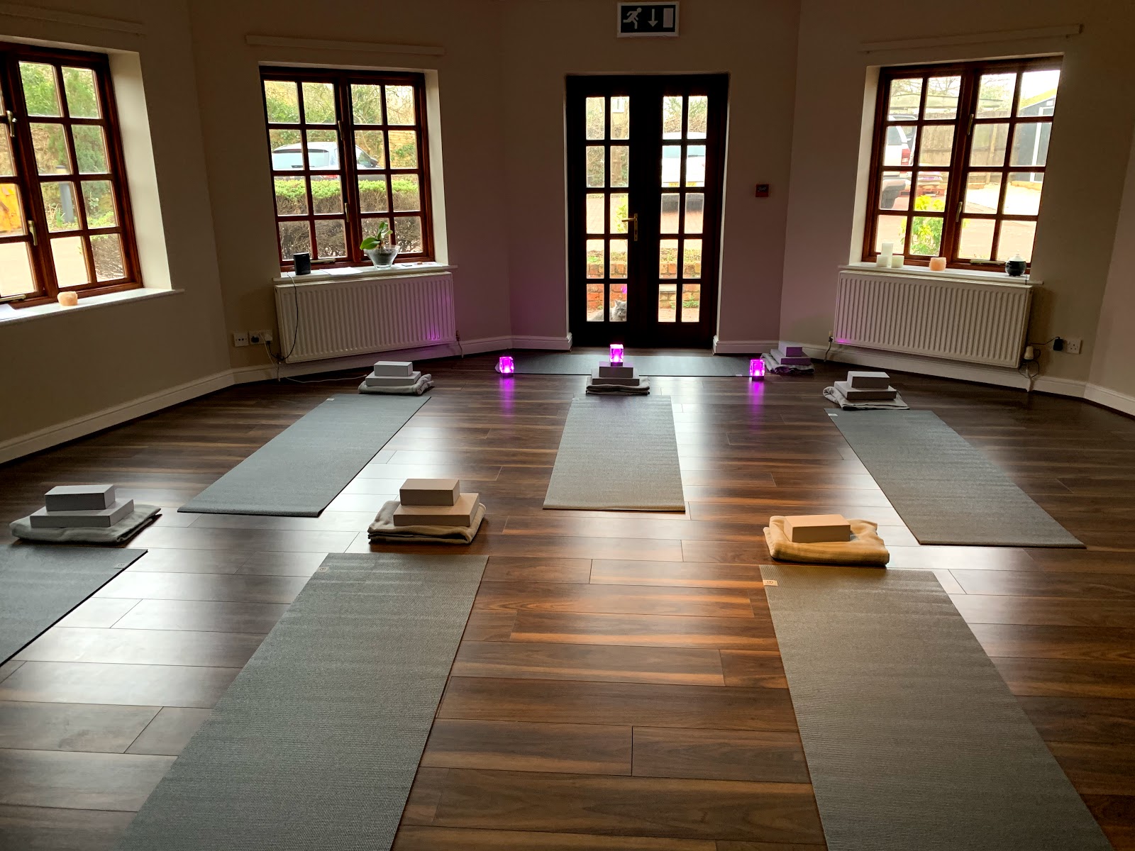 Bright yoga studio at The Roade House in Roade, with mats set out for a wellness class.